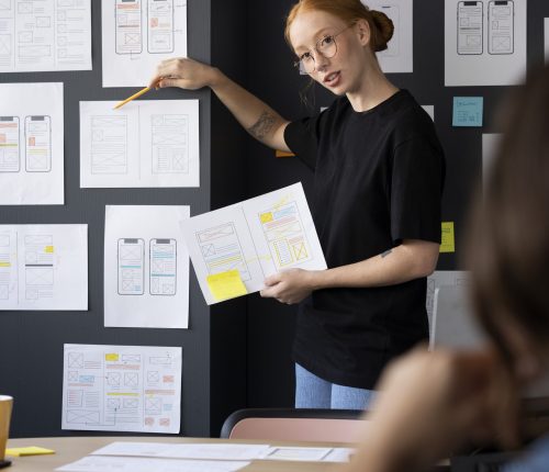 female-web-designer-with-papers-notes-office